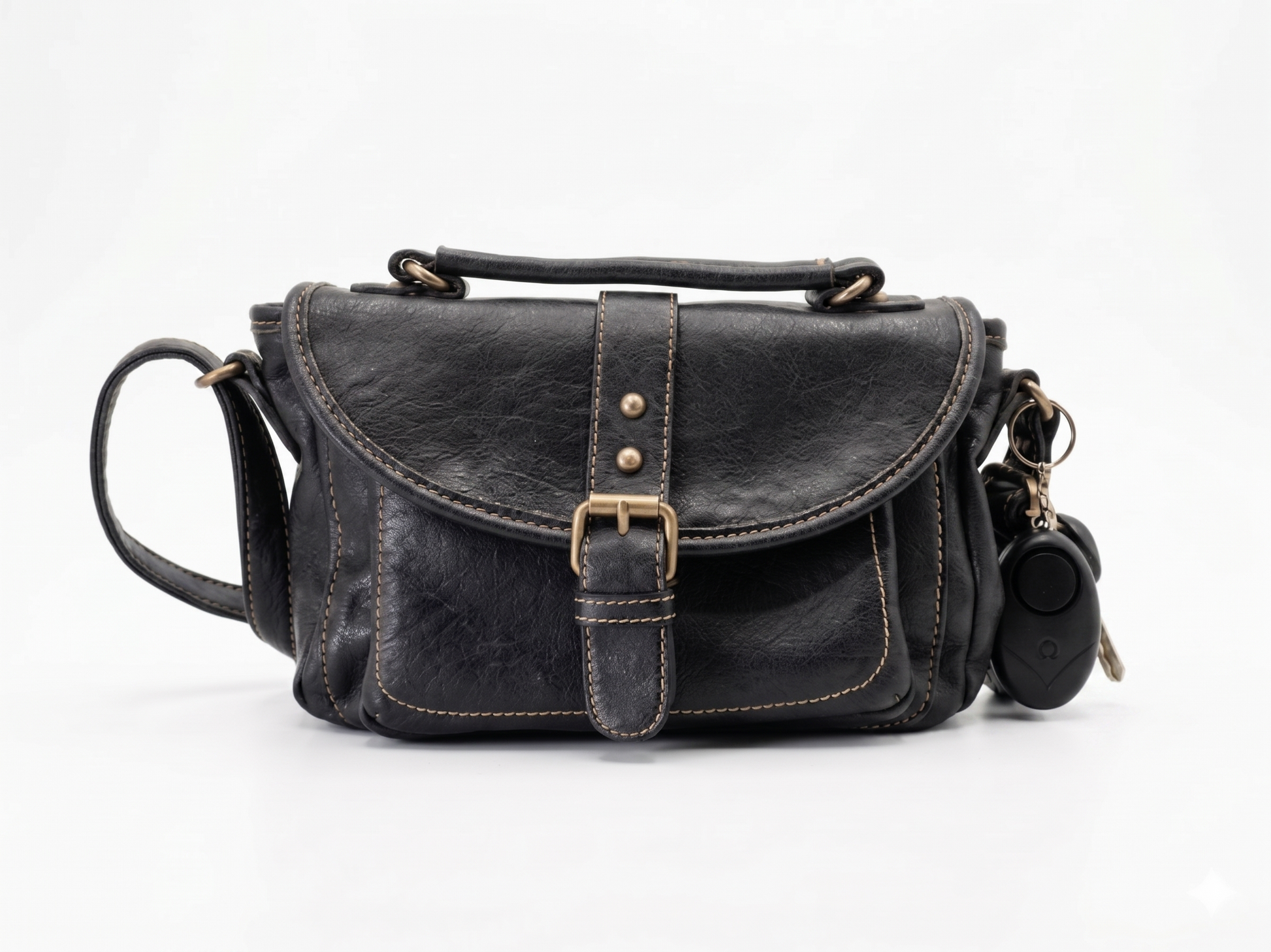 Black leather handbag with a SafeHer alarm attached to a white background